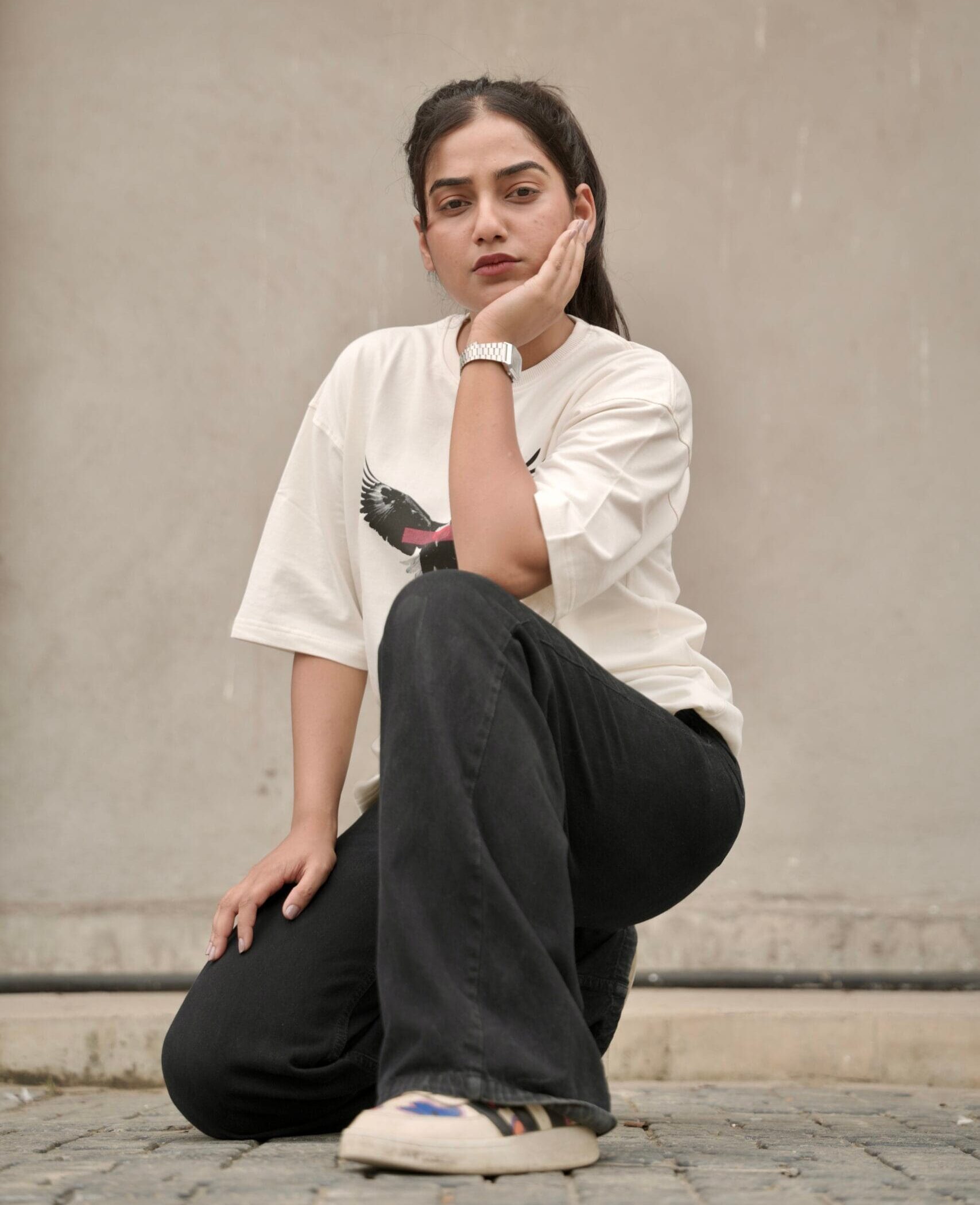 a girl wearing yeefoo t-shirt outdoors with a serious look