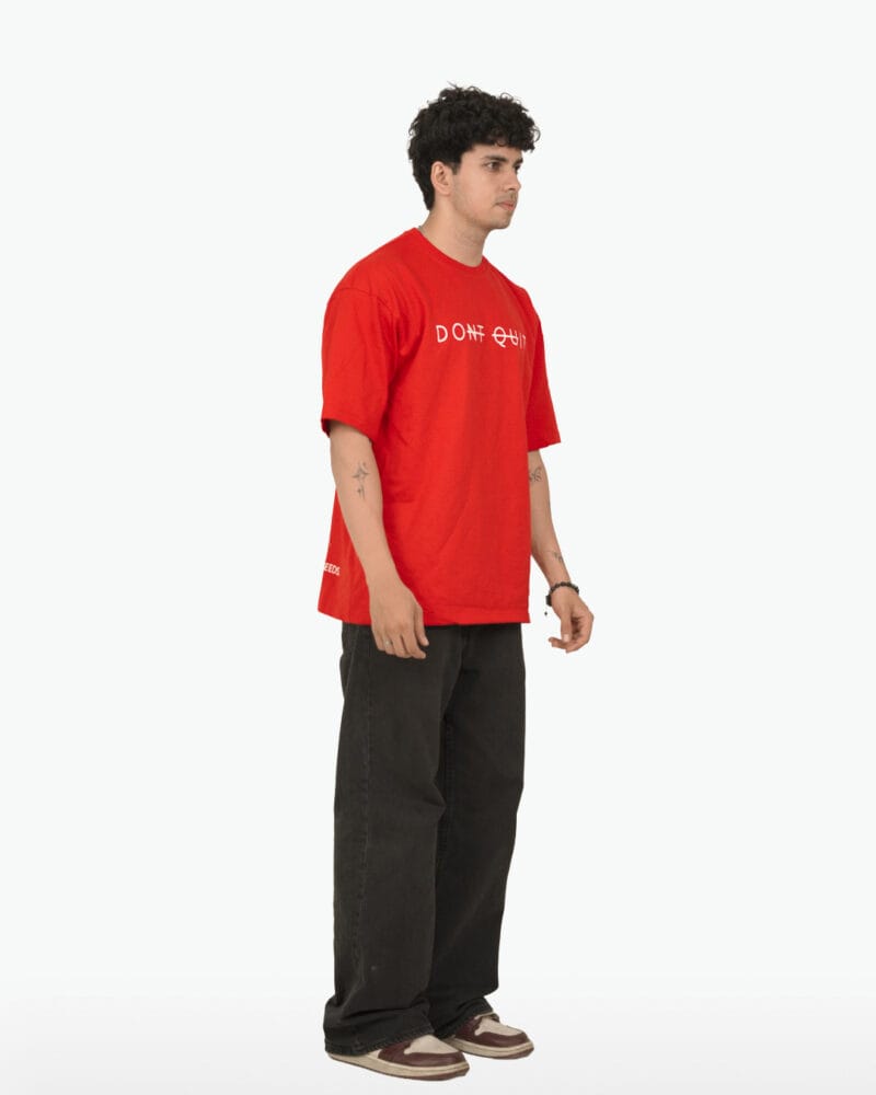 Side profile view of the Don't Quit oversized tee showing the drop shoulder and fit.