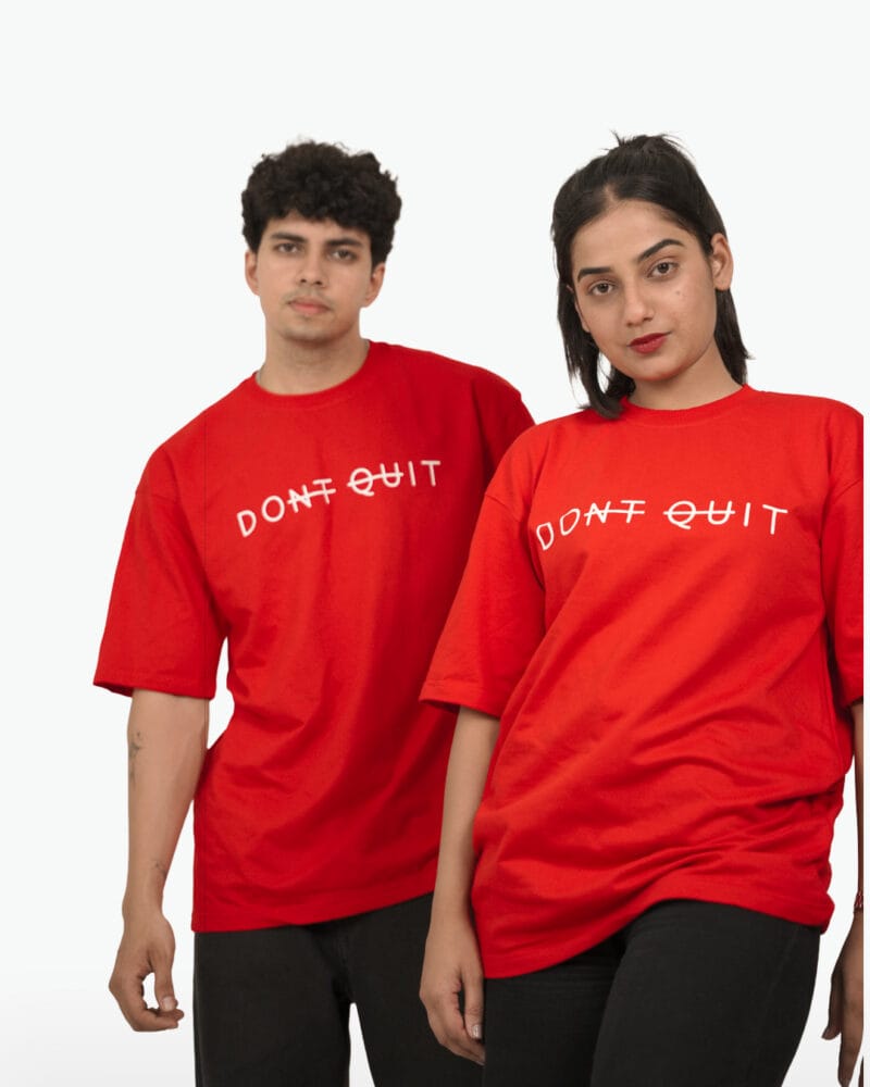 Male and female models wearing the matching red Yeefoo Don't Quit oversized t-shirt.