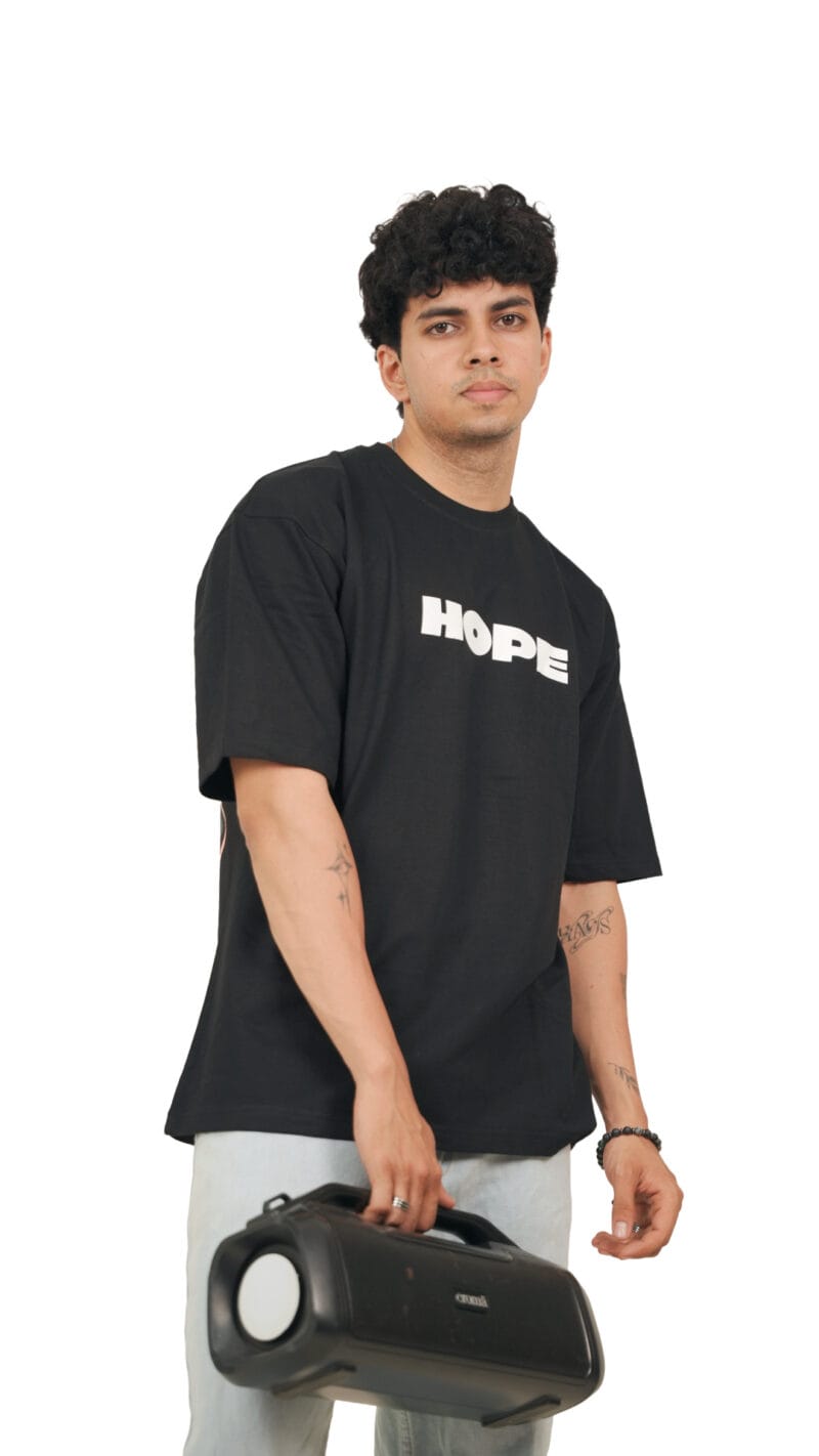 Angled view of the model wearing the black Futuristic Graphic T-Shirt.