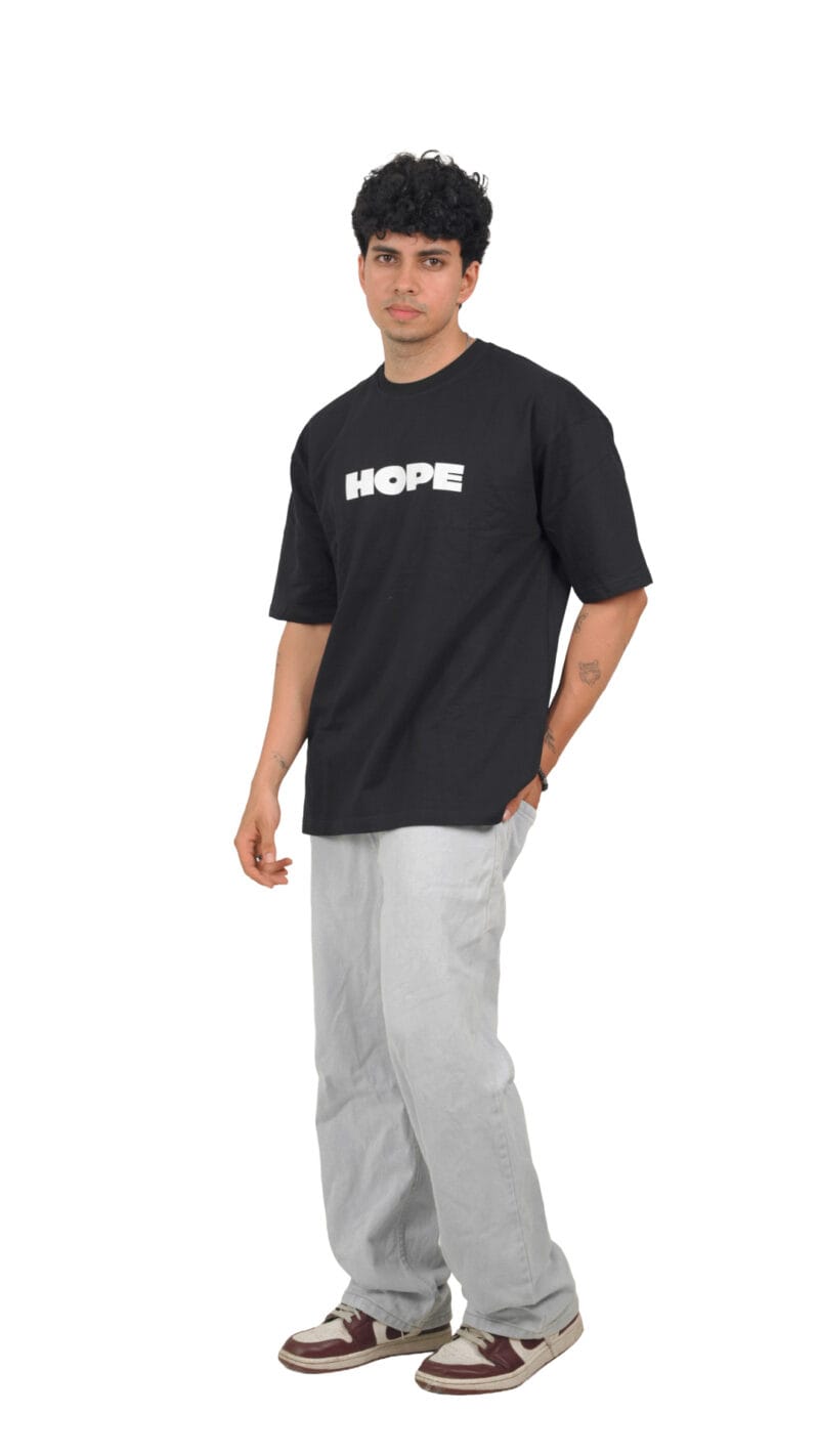 Angled view of the model wearing the black Futuristic Graphic T-Shirt.