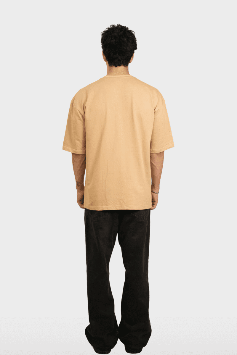 Back view of the oversized Personality Tee in Sand, showing the clean back.
